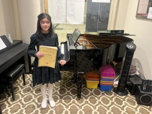 Piano student smiling at a masterclass workshop